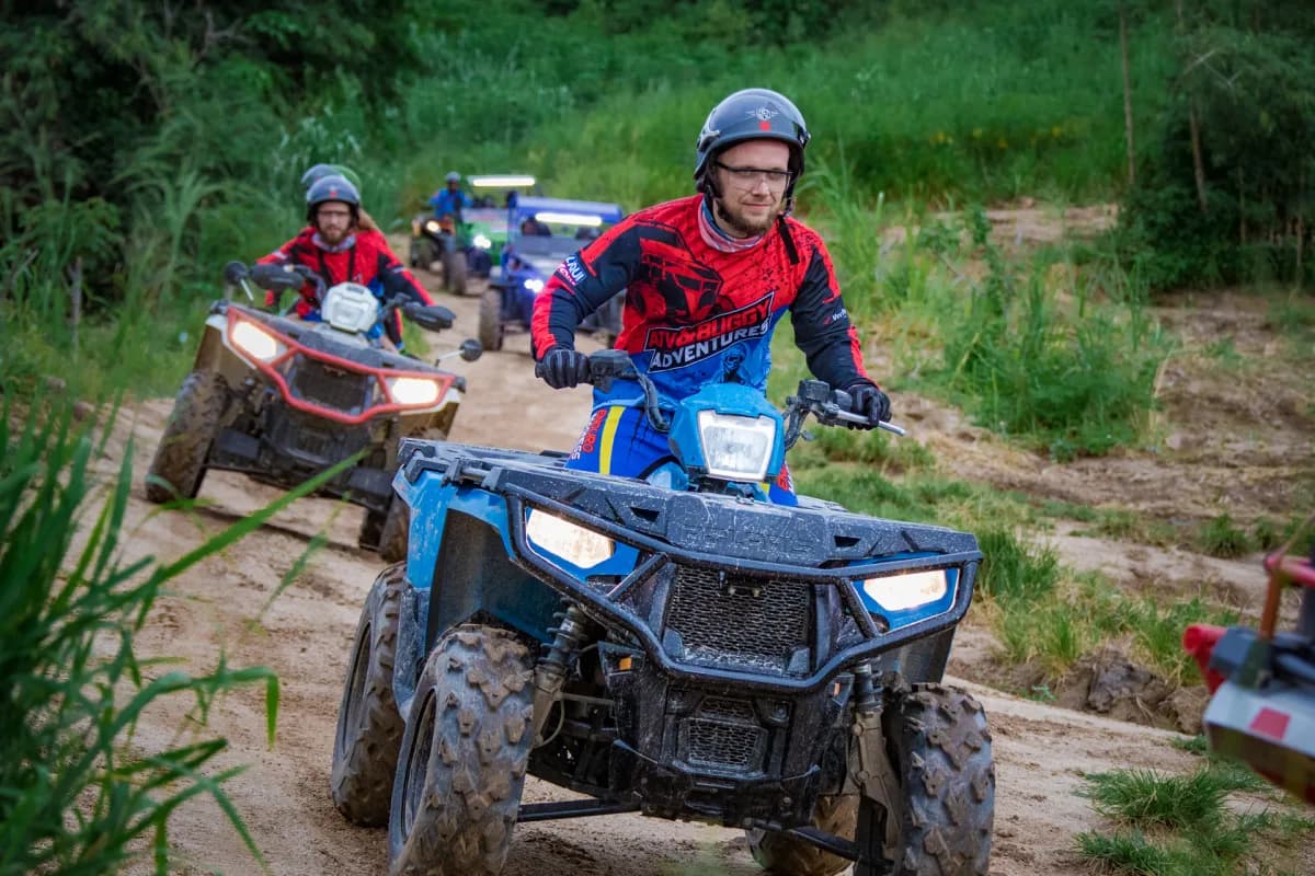 ATV riders in convoy on the Explorer Tour trail through jungle near Pattaya