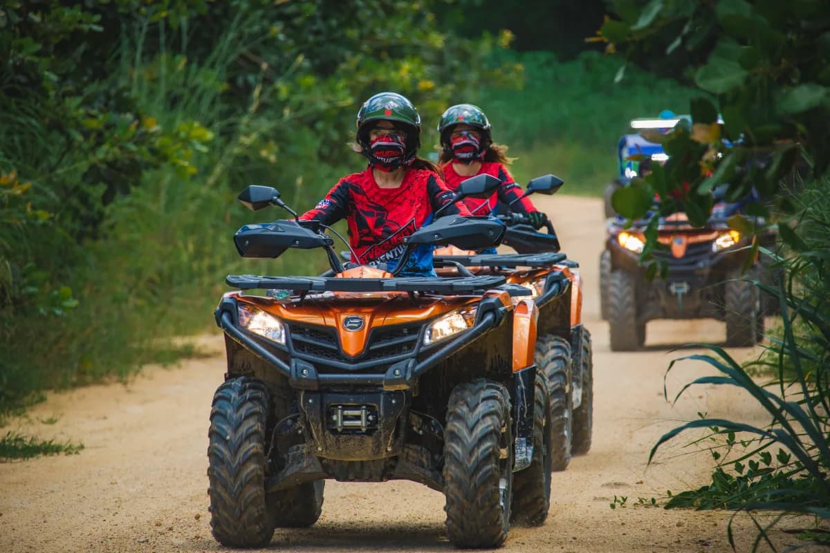 ATV riders on an off-road trail through the Thai countryside near Pattaya